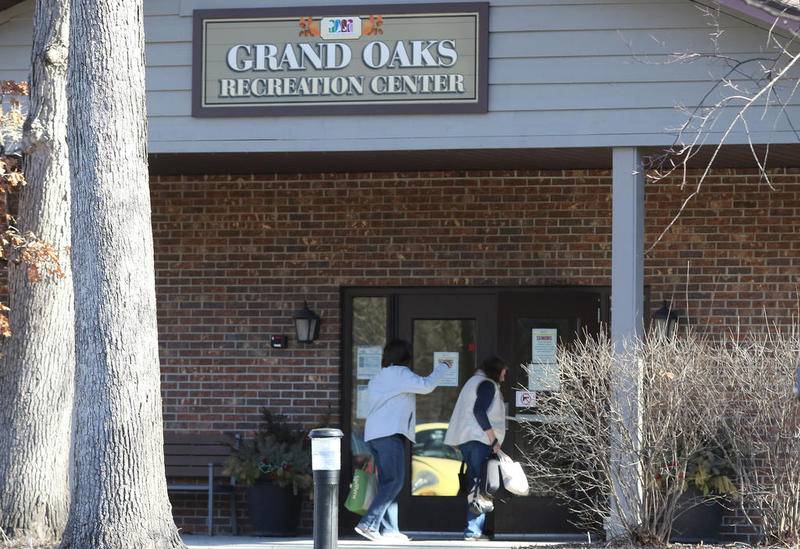 People walk into Grand Oaks Recreation Center on Friday, March 13, 2020, in Crystal Lake.