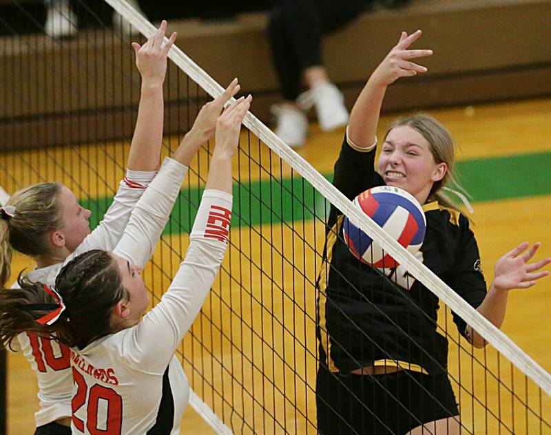 Putnam County's tori Balma (12) misses the return block of Henry's Abbie Stanbary (10) and teamate Catherine Miller in the Tri-County Conference Tournament on Monday, Oct. 10, 2022 in Seneca.