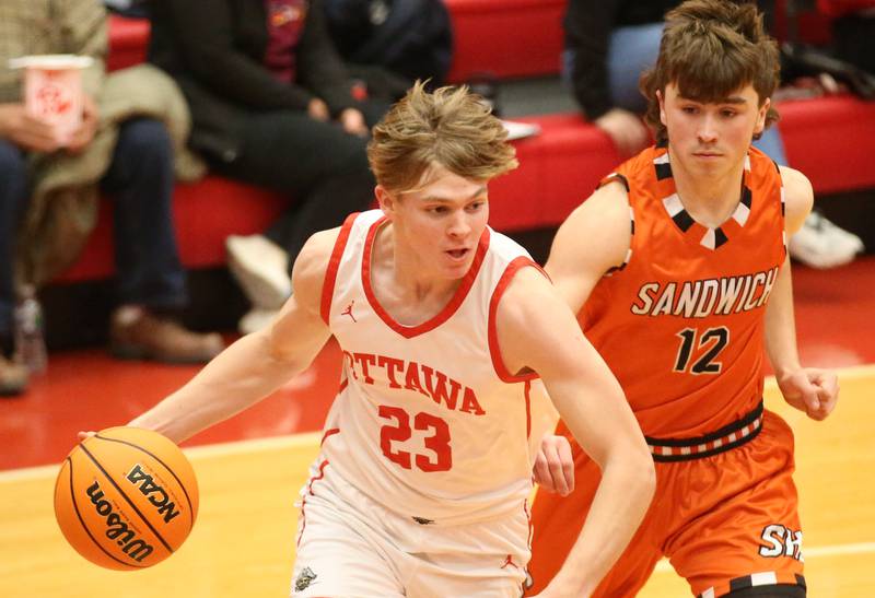 Ottawa's Owen Sanders runs around Sandwich's Braden Behringer on Wednesday, Dec. 4, 2024 in Kingman Gym at Ottawa High School.