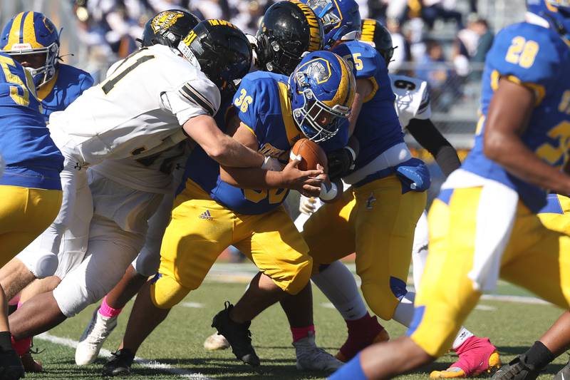 Joliet Central’s Xavier Serna runs up the middle against Joliet West in the cross town rival matchup on Saturday.