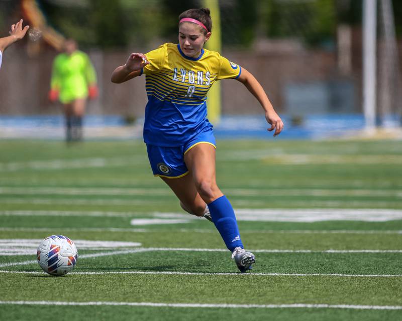 Lyons Township's Katie O'Malley (9) advances the ball during Class 3A Lyons Regional final soccer match between Glenbard West at Lyons Township.  May 21, 2023.