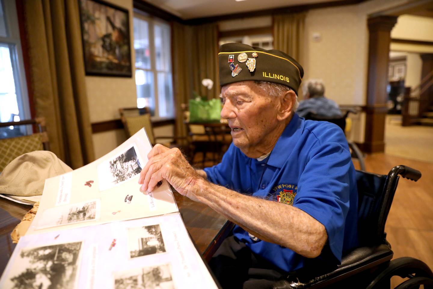 Veteran Art Hrabec, 101, of Lombard looks through a memory book made by one of his grandchildren. Hrabec served in Europe during WWII.