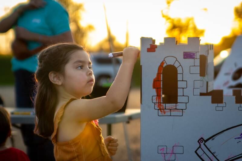 Elena Torres paints a castle Friday, Aug. 23, 2024, at Family Safe Night outside of the Mendota Civic Center.