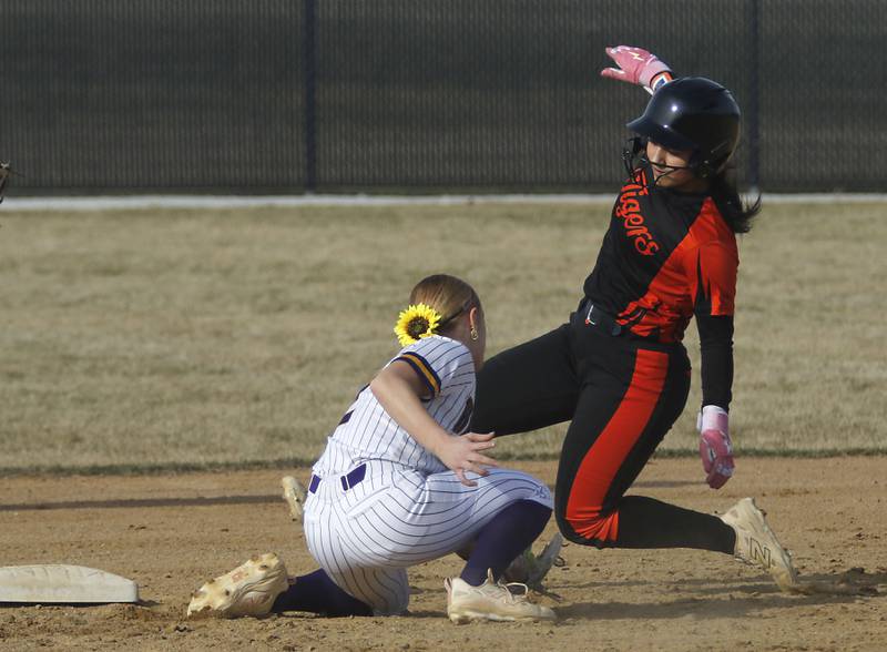 Crystal Lake Central's Logan Grams slides into second base as Wauconda's Ainsleigh Buse tries to tag her during a nonconference softball game on Friday, March 20, 2026, at Crystal Lake Central High School.