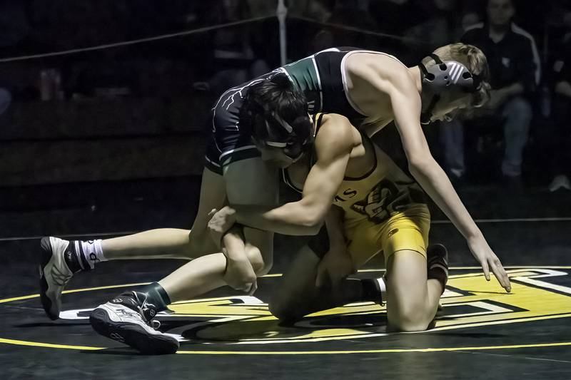 Riverdale's Dean Wainwright (bottom) grabs the leg of West Carroll's Connor Knop during the 106-pound title bout at the 1A Riverdale Regional on Saturday, Feb. 4, 2023.