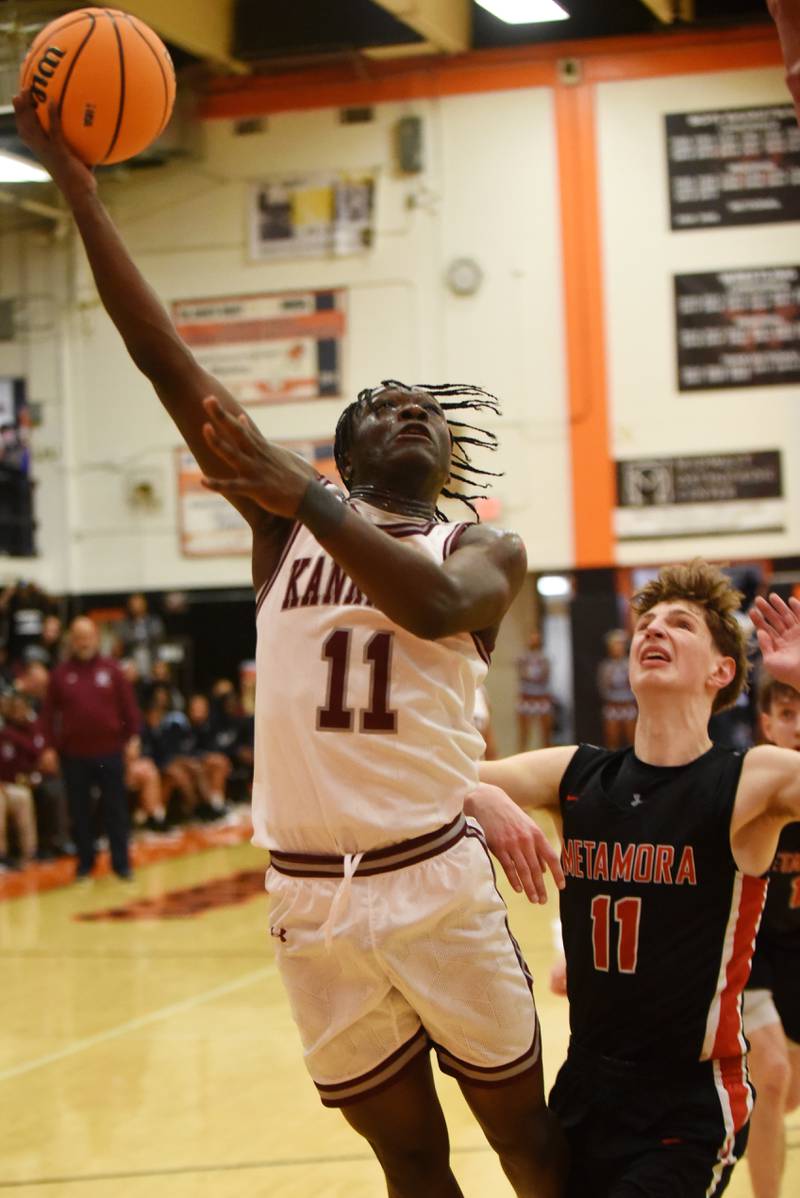 Kankakee's Jordan Davis, left, lays it up in front of Metamora's Colin Ramage during the IHSA Class 3A Washington Sectional semifinals Tuesday, March 4, 2025.