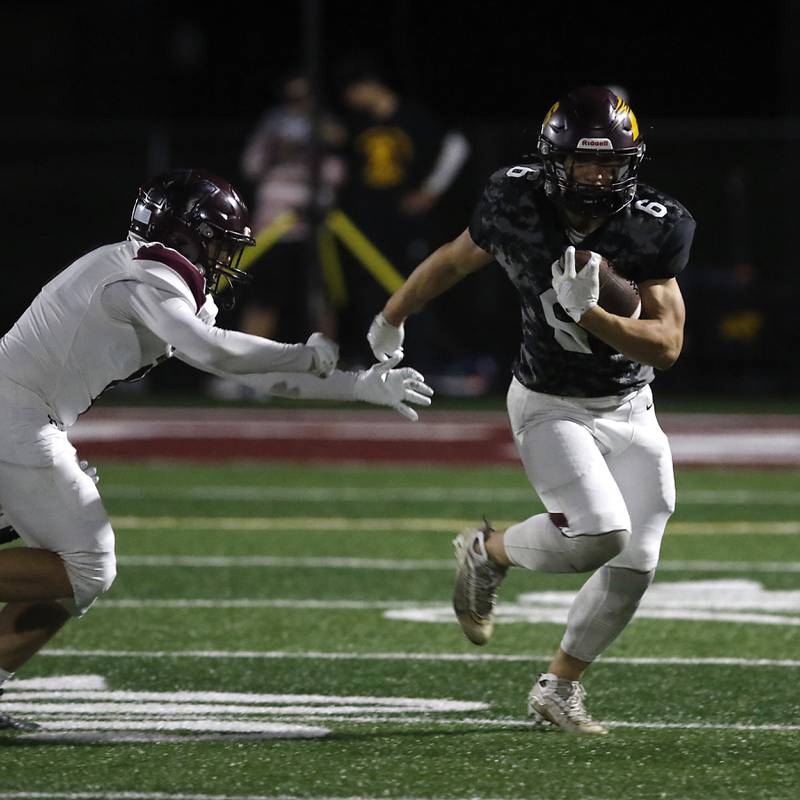 Richmond-Burton's Hunter Carley runs away from Marengo's Brody Carney a Kishwaukee River Conference football game on Friday, Oct. 17, 2025, at Richmond-Burton High School in Richmond.