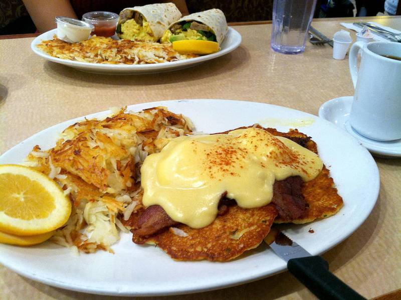 The German Benedict (foreground) at Randall's Pancake House in South Elgin comes with two crispy potato pancakes topped with bacon, poached eggs and hollandaise sauce. The Breakfast Burrito pictured here included a large flour tortilla stuffed with scrambled eggs, sausage, green peppers, black olives, cheddar cheese and avocado.