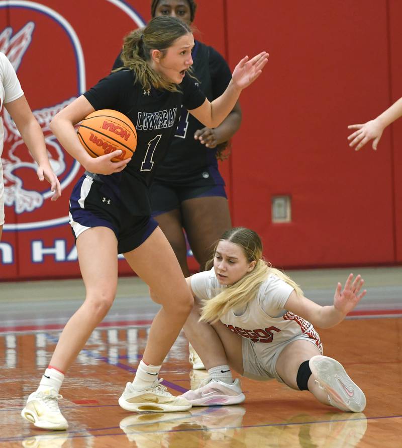Oregon's Airael Schutz (20) falls to the floor after reaching for the ball as Rockford Lutheran's Soraya Parker (1) reacts on Saturday, Jan. 24, 2026 at the Blackhawk Center in Oregon.