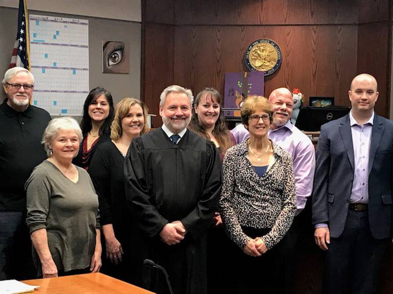 Judge Christopher Harmon joins a group of volunteer court-appointed special advocates at their 2019 swearing-in ceremony at the McHenry County courthouse in Woodstock.