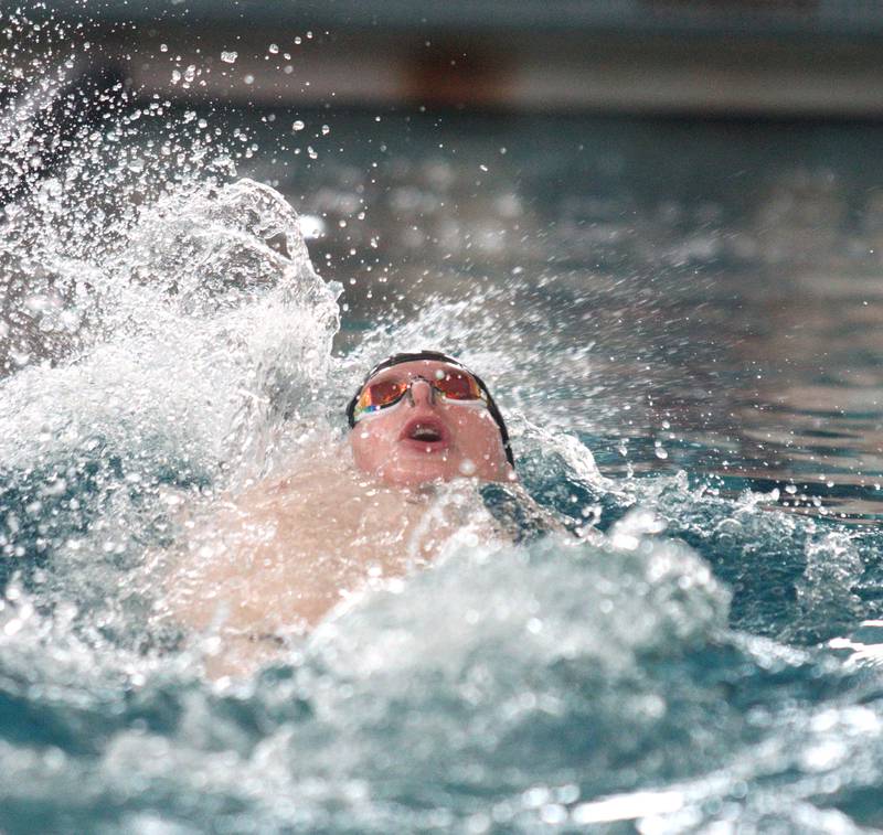 Drew Watson of Cary-Grove co-op swims the backstroke leg of the 200-Yard Medley Relay during the Fox Valley Conference Swimming Championships at Woodstock North High School Saturday.