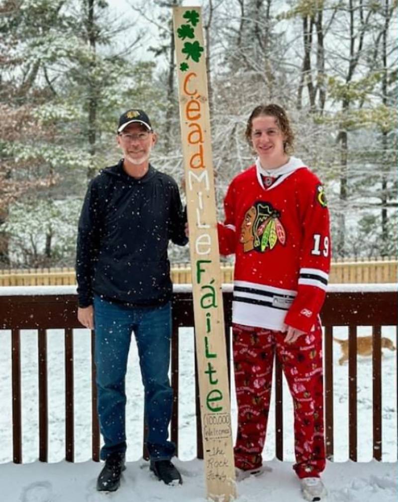 Mike Rock of Byron poses with his son, Mike, and their family's decorated stud. Maggie Rock is on the board of Habitat for Humanity of Ogle County and the Rocks decided to draw upon their Irish heritage to decorate their stud.  It translates to "100,000 Welcomes", a perfect message to be placed into the house of next homeowners.