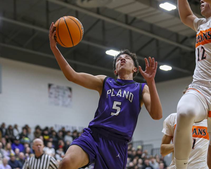 Plano's Eric Nunez (5) goes in for a layup attempt during their basketball game between Sandwich at Plano Tuesday, Jan 27, 2026 in Sandwich.