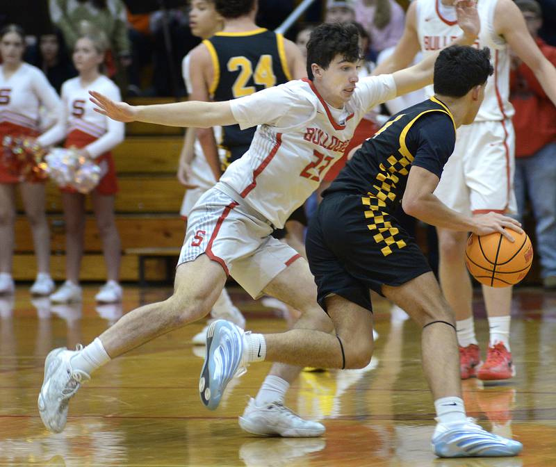 Streator’s Colin Byers works to stop the drive of Reed Custer’s Chase Isaac in the 2nd period Tuesday at Streator.