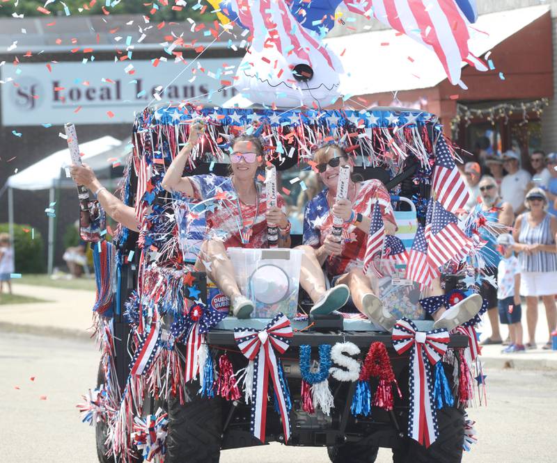 Theresa Gabrielson''s "Just for Fun" friends shoot off confetti as they pass the reviewing stand during the Let Freedom Ring parade on Friday, July 4, 2025 in Mt. Morris. The entry won the "Best Patriotic Entry".