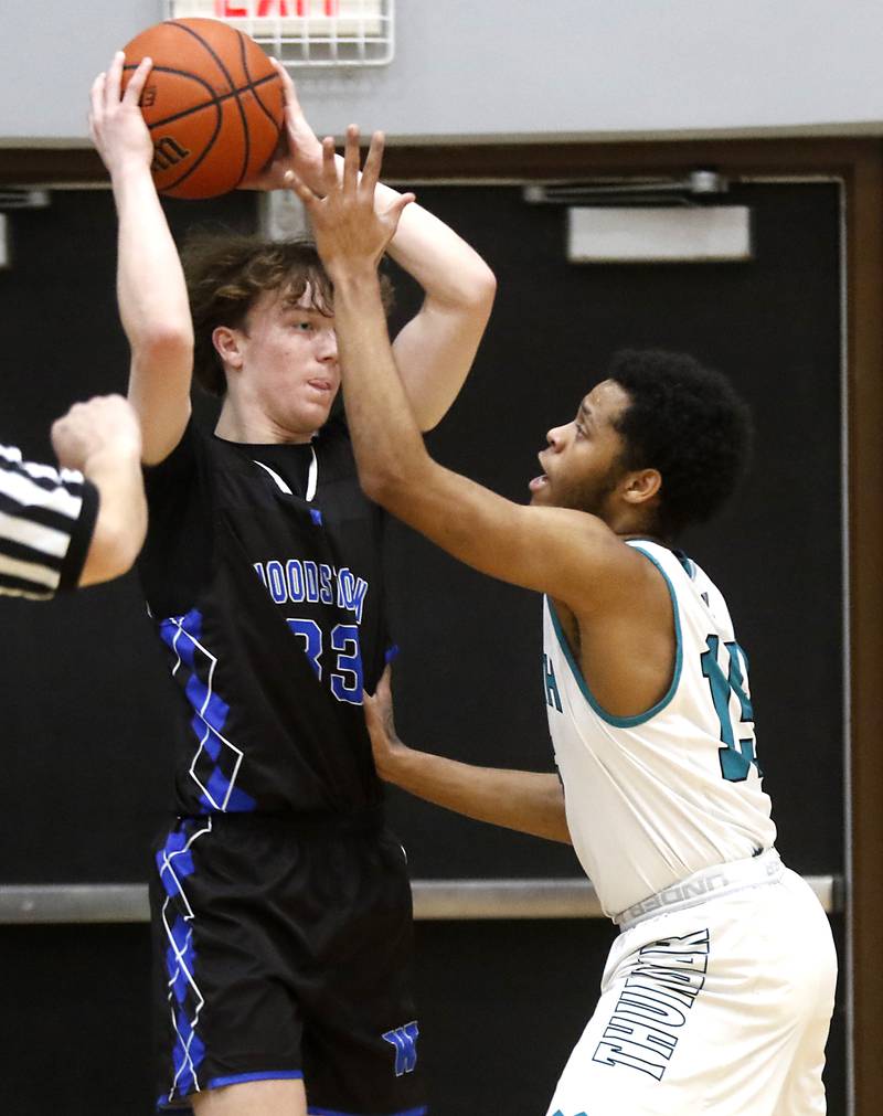 Woodstock's Samuel Chapman looks to pass as he is defended by Woodstock North’s Darnell McMiller during a Kishwaukee River Conference boys basketball game on Friday, Jan. 5. 2024, at Woodstock North High School.