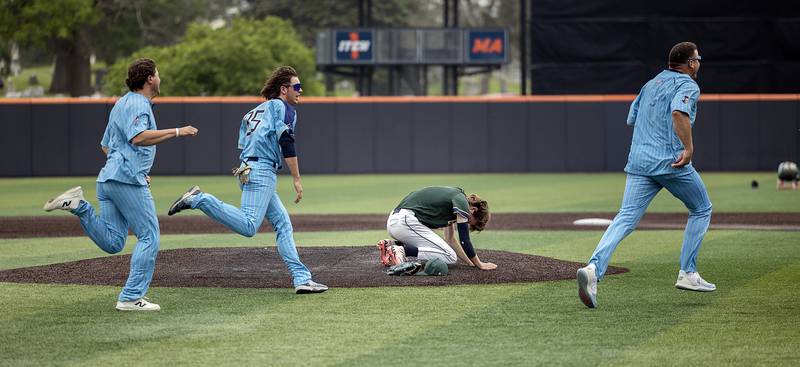 Father McGivney’s Evan Koontz drops to the ground after giving up a walk off single to end the game against Ottawa Marquette Saturday, June 7, 2025, during the Class 1A state baseball final at Illinois Field in Champaign.