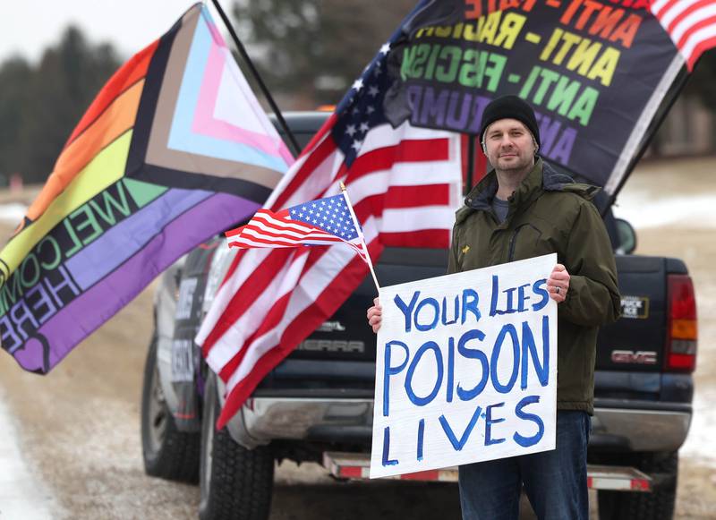 Michael Hamby, from Genoa, holds a sign Thursday, Feb. 5, 2026, in front of Genoa-Kingston High School. The group is protesting the “History Rocks” assembly which is part of a nationwide campaign by the U.S Department of Education tied to the nation’s 250th anniversary and organized by the high school’s Turning Point USA, Club America chapter, a nonprofit founded in 2012 by the late Charlie Kirk.