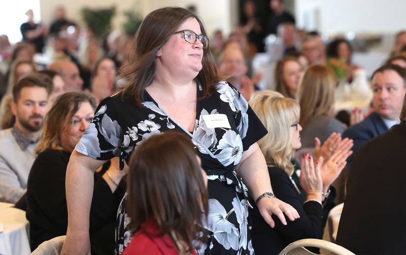 Kari Maratos, co-owner of the Sycamore State Theater, comes up to accept the Sycamore Chamber of Commerce Community Diamond Award on behalf of the theater during the 106th Annual Chamber Meeting Thursday, March 2, 2023, in Memorial Hall at St. Mary's Catholic Church in Sycamore.