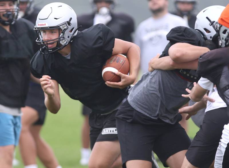 Kaneland quarterback Troyer Carlson finds some running room during practice Wednesday, Aug. 9, 2023, at the school in Maple Park.