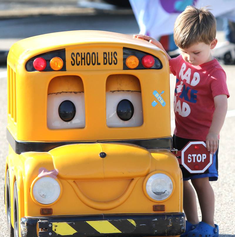 RJ Pepperman, 2, from Sycamore, talks to Buster the school bus from the DeKalb County Regional Office of Education Tuesday, Aug. 2, 2022, during National Night Out in the parking lot of the Walmart on Sycamore Road in DeKalb.
