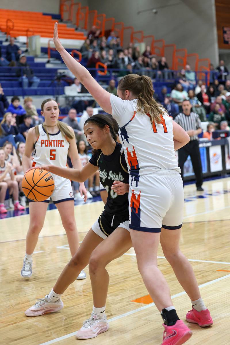 Bishop McNamara’s Trinitee Thompson drives against a defender toward the lane during the Fightin’ Irish’s 46-32 loss to Pontiac in the IHSA Class 2A Pontiac Sectional semifinal on Tuesday, Feb. 24, 2026, at Pontiac Township High School.