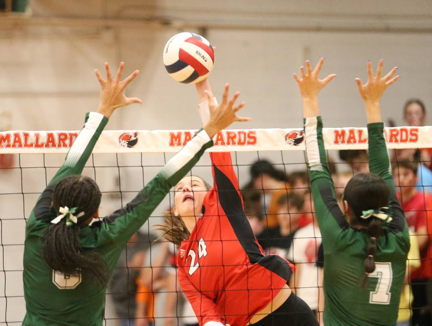 Henry-Senachwine's Harper Schrock sneaks a kill between St. Bede's Kijah Lucas and teammate Kate Duncan on Tuesday, Oct. 21, 2025 at Henry-Senachwine High School.