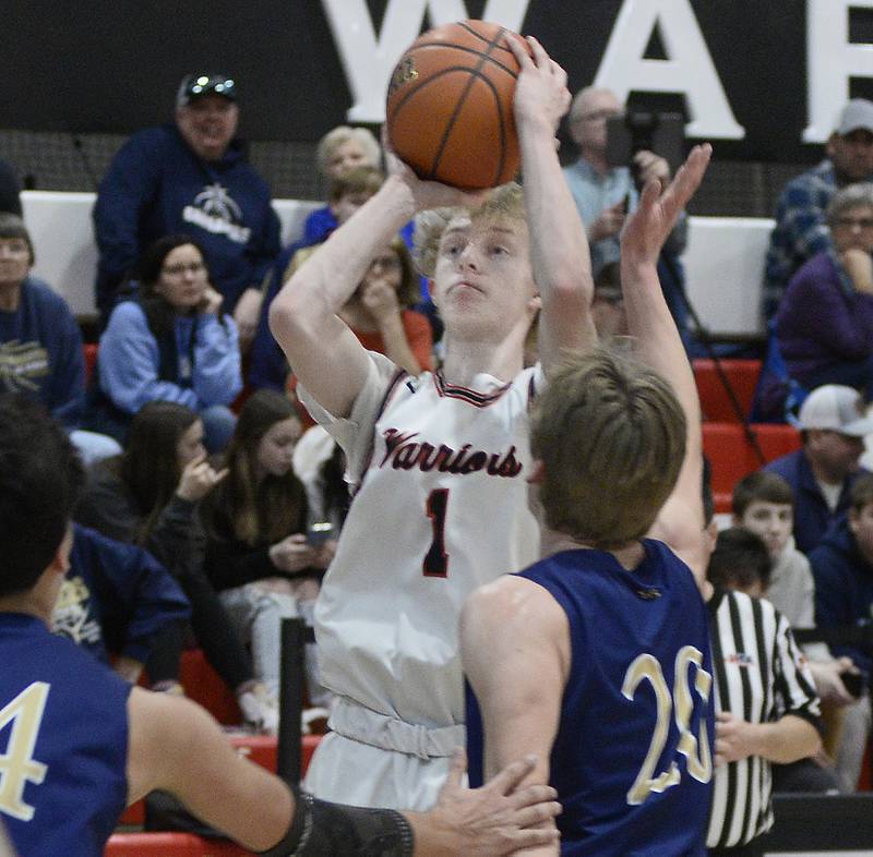 Woodland’s Connor Dodge (1) shoots over the block attempt of Marquette’s Logan Nelson on Friday, Feb. 10, 2023, at the Warrior Dome.