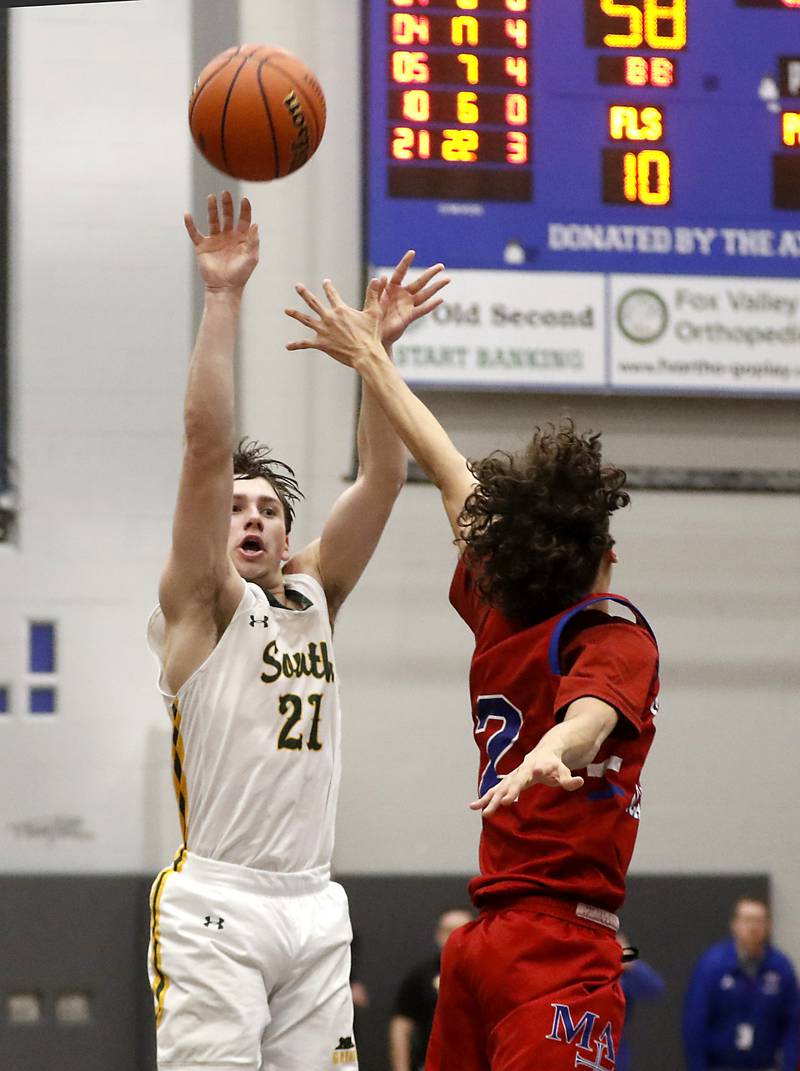 Crystal Lake South's Cooper LePage shoots the ball over Marmion’s Jabe Haith in the final seconds of a IHSA Class 3A Sectional boys basketball game Tuesday, Feb. 28, 2023, at Central High School in Burlington.