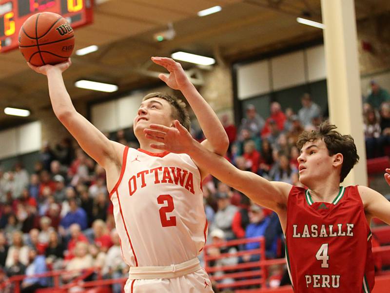Ottawa's Hunter Hart shoots a shot over L-P's Jack Jereb in Kingman Gymnasium on Friday, Feb. 10, 2023 at Ottawa High School.