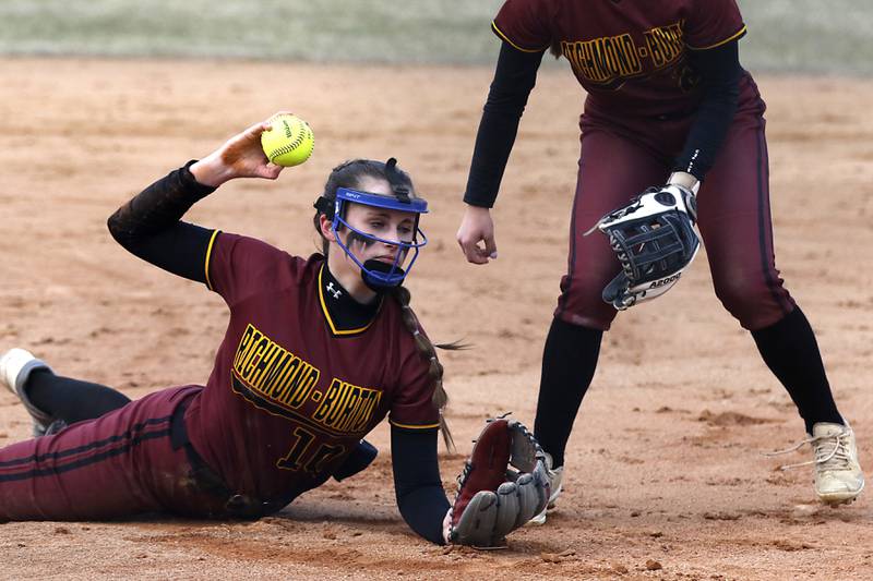 Richmond-Burton’s Hailey Holtz tries to make a throw to first base during a non-conference softball game against Cary-Grove Tuesday, March 21, 2023, at Cary-Grove High School.