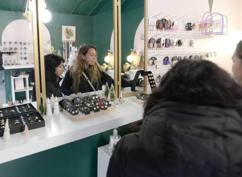 (left) Ella Herrera and Gina Santellano of Chicago look at some of the jewelry inside one of the Berwyn Shops during the Pop-Up Market held Saturday Dec 10, 2022.
