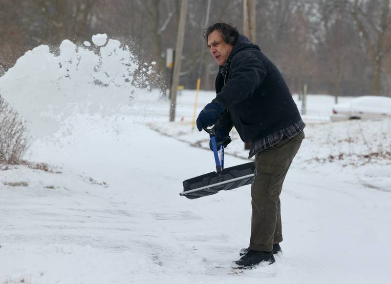 Peter Broughton, from DeKalb, shovels his driveway Wednesday, Feb. 12, 2025, in DeKalb.