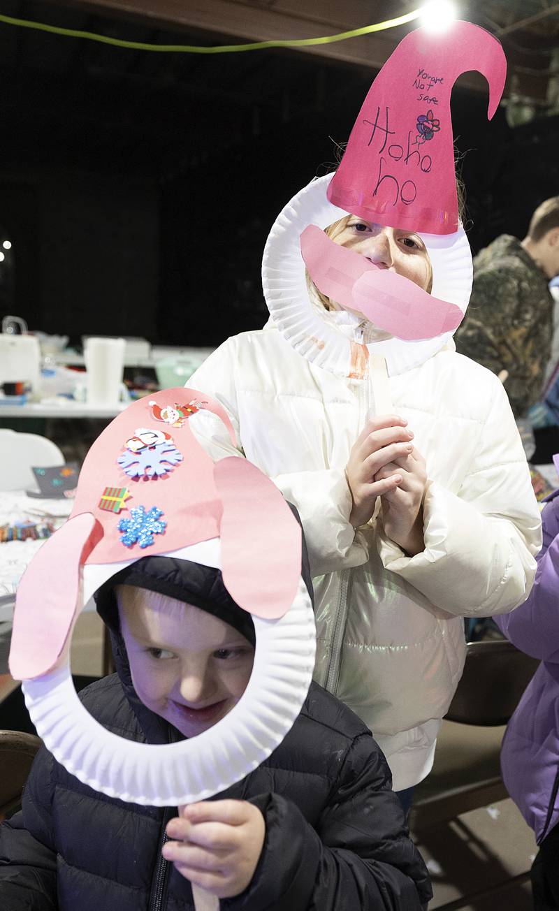 Robbie Prescott, 6, and sister Raegan, 9, show off their elf masks Friday, Dec. 6, 2024, at Santa’s workshop hosted by the city of Sterling.