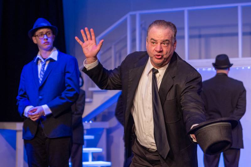 “Jeff Sudakov” (Played by Carl Hanratty) holds hat and sings on Monday, March 24, 2025 at River Valley Players Theatre in Henry.