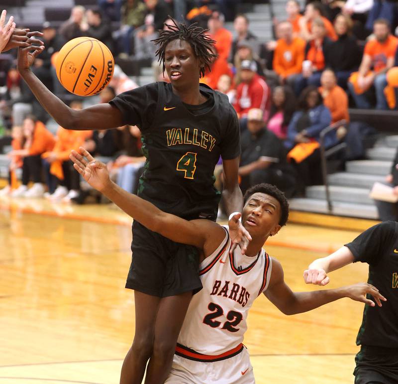 Waubonsie Valley's Moses Wilson and DeKalb's Justin O'Neal go after a rebound during their game Friday, Feb. 21, 2025, at DeKalb High School.