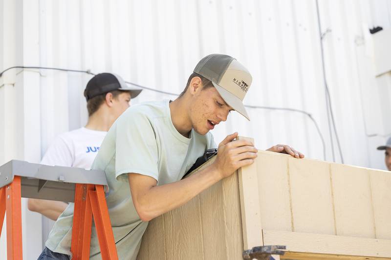 Justin Collins, Oregon Ag Construction student, works Friday, May 16, 2025, on the mini-food center at Dixon Public Library. Due to the placement of the center, the class worked on-site for the construction for the first time.