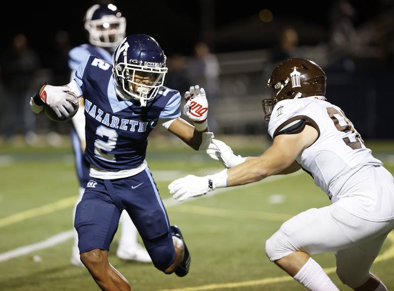 Nazareth's Garrett Reese (2) runs the ball during the varsity football game between Joliet Catholic and Nazareth academies on Friday, Sep. 27, 2024 in La Grange Park.