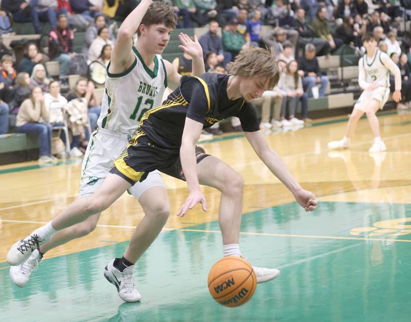 Putnam County's Jacob Furar falls on a loose ball as St. Bede's Carson Riva defends during the Class 1A Regional quarterfinal game on Monday, Feb. 23, 2026 at St. Bede Academy.