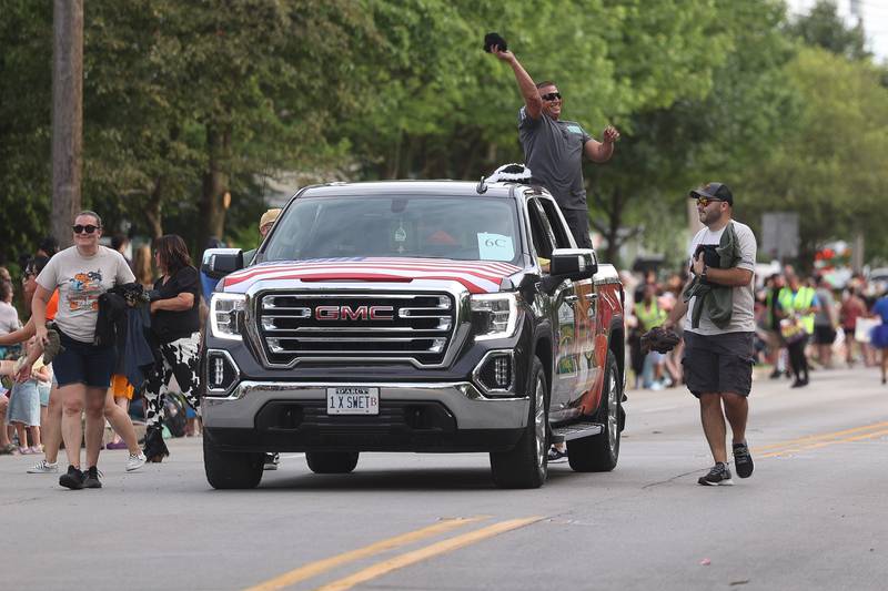 Cottonwood Farms throws out tee shirts to the crowds in the Old Canal Days Parade on Friday June 7, 2024 in Lockport.