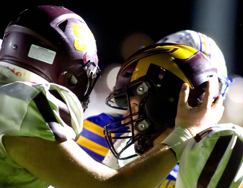 Richmond-Burton’s Hunter Carley, right, is greeted in the end zone after scoring a touchdown in IHSA football Class 3A second-round playoff action at Bob Stewart Field on the campus of Aurora Central Catholic High School in Aurora on Friday, November 7, 2025.