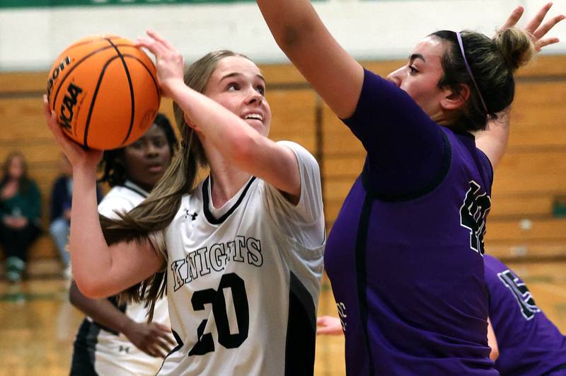 Kaneland's Samantha Kerry tries to shoot over Dixon’s Hallie Williamson during their Class 3A sectional semifinal game Tuesday, Feb. 25, 2025, at Boylan Catholic High School in Rockford.