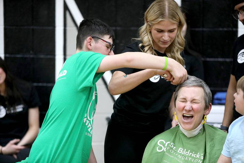 Martin Elementary School special education teacher Jennifer Slad has her head shaved with the help of her former student, Matthew Erickson, at Marlowe Middle School in Huntley for a St. Baldrick’s Foundation fundraiser. Slad shaves her head in honor of Matthew, who is a cancer survivor.
