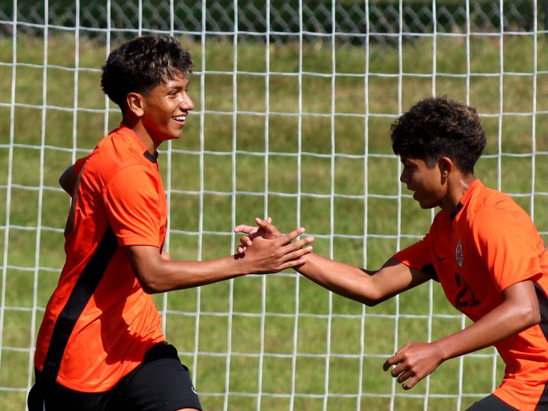 Crystal Lake Central’s Ulisses Mateos, left, is greeted by Gianluca Gonzalez after the Tigers’ second goal against Harvard in varsity boys soccer at Crystal Lake Central High School in Crystal Lake on Saturday, Sept. 6, 2025.