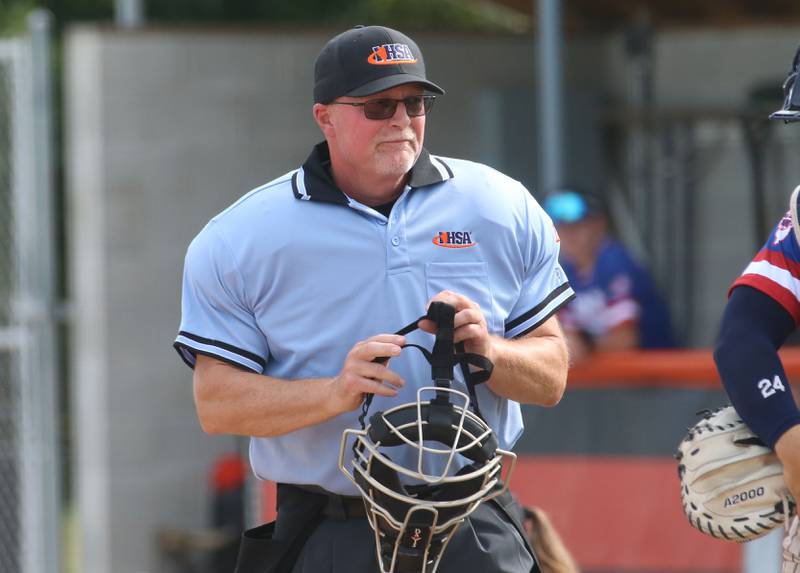 Home plate umpire Jim Heth grabs his head hear during the ICA Senior Baseball All Star Game on Monday, June 30, 2025 at Schweickert Stadium in Peru.