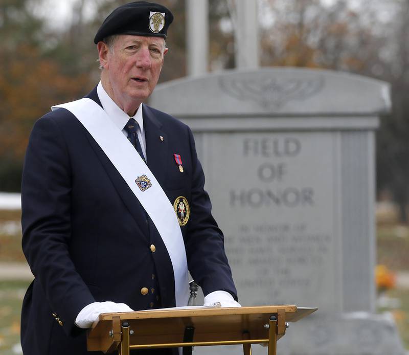 Bob Schafer speaks during the Veterans Day flag placement ceremony Tuesday, Nov. 11, 2025, at the gravesites of veterans at McHenry County Memorial Park Cemetery in Woodstock. Members of the Knights of Columbus Patriotic 4th Degree from the Bishop Boylan Assembly placed American Flags at nearly 140 veterans' grave markers.
