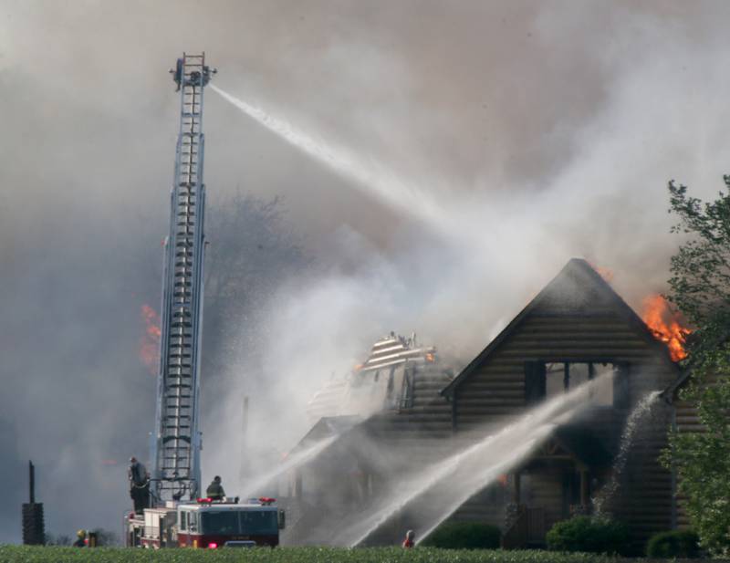 La Salle firefighters use their aerial fire truck to fight a five-alarm fire at the Grand Bear Resort on Monday, May 30, 2022 in Utica.