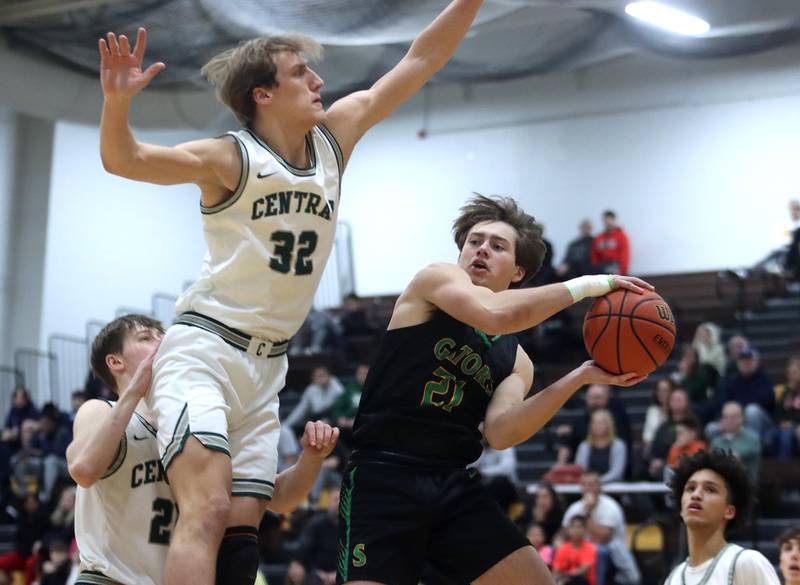 Crystal Lake South’s Cooper LePage, right, battles Grayslake Central’s Jake Gibson, left, during Hinkle Holiday Classic Basketball Tournament title game action at Jacobs High School Friday.