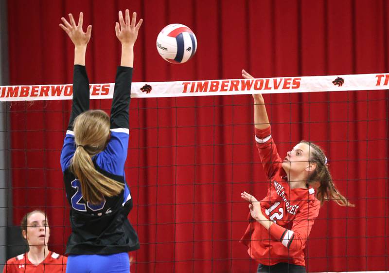 Indian Creek's Taylor Edwards tries to spike the ball past the block attempt by Hinckley-Big Rock's Amelia Galles during their match Tuesday, Sept. 9, 2025, at Indian Creek High School in Shabbona.