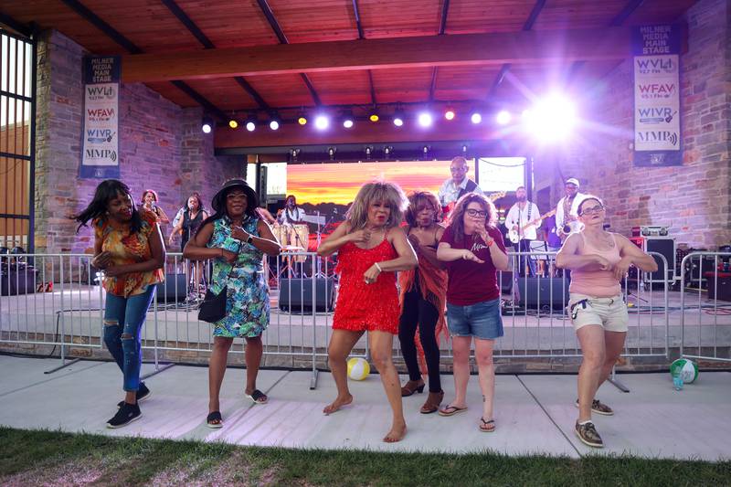 Dorothy Roberson, center, dances with attendees as she performs a Tina Turner tribute show during the 50th Bourbonnais Friendship Festival at The Grove on Saturday, June 28, 2025.